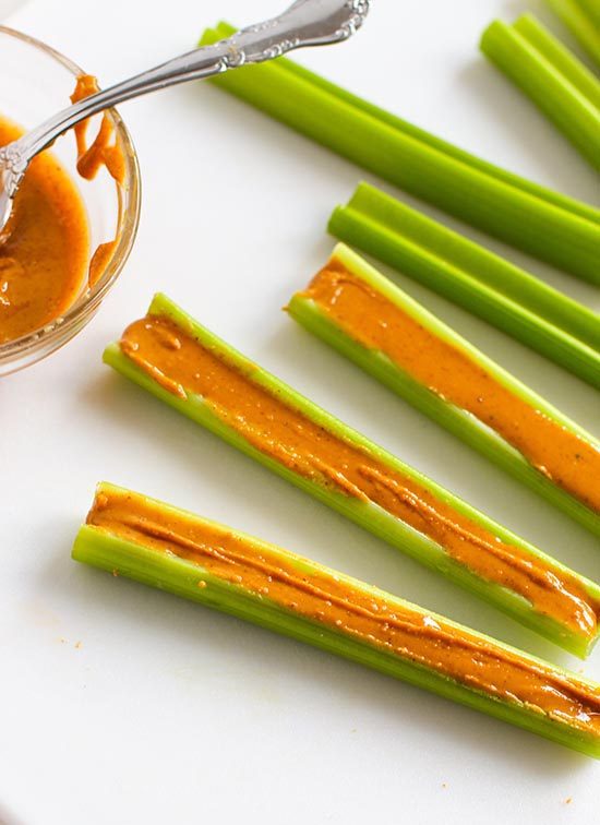 spoon peanut butter into celery sticks fountainof30