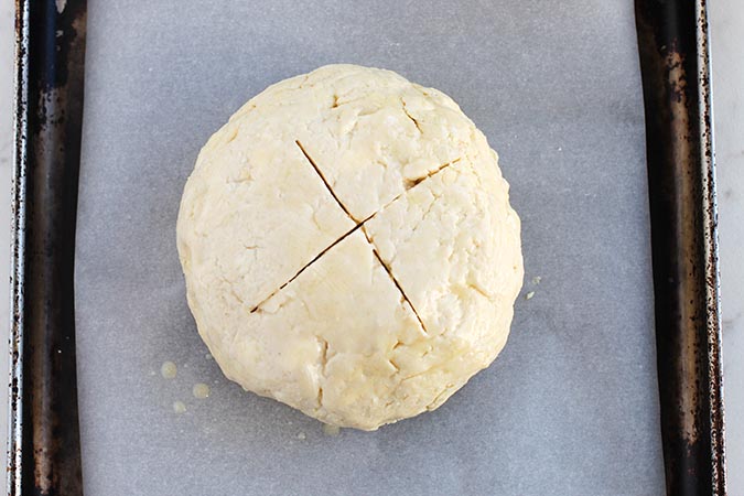 dough ball crisscross cut on parchment baking sheet fountainof30