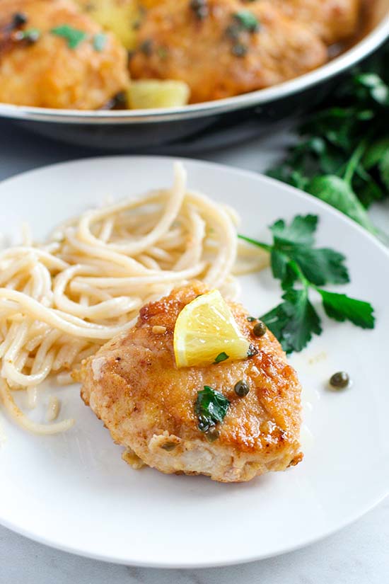 Chicken Piccata serving with a side of pasta fountainof30