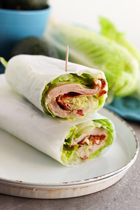 turkey club wrap serving with toothpick on a plate fountainof30