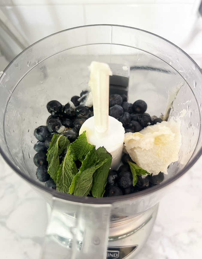 blueberries in food processor with mint sprig fountainof30