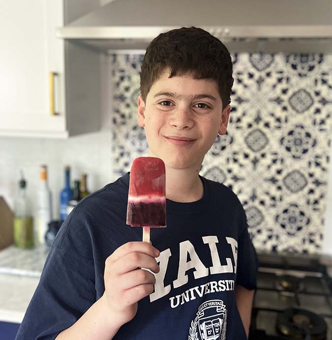 boy holding Healthy Red White And Blue Popsicle fountainof30