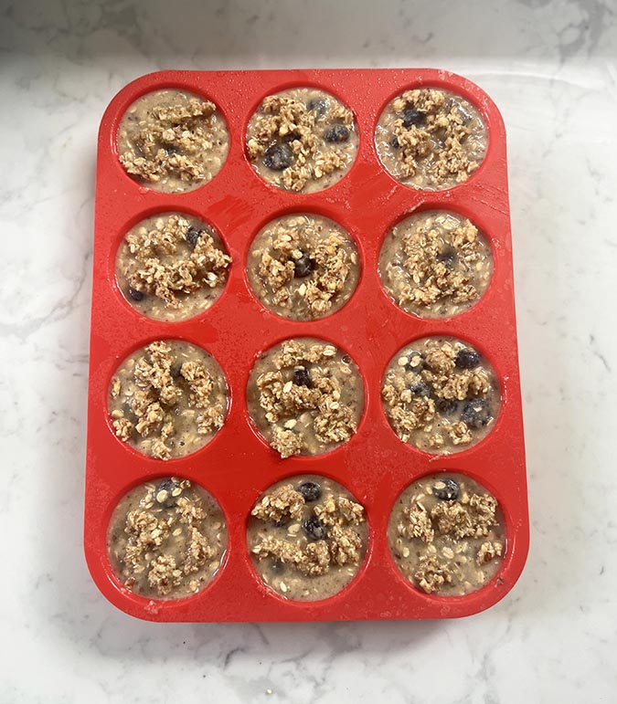 Blueberry Oatmeal Protein Muffins b atter in muffin pan fountainof30
