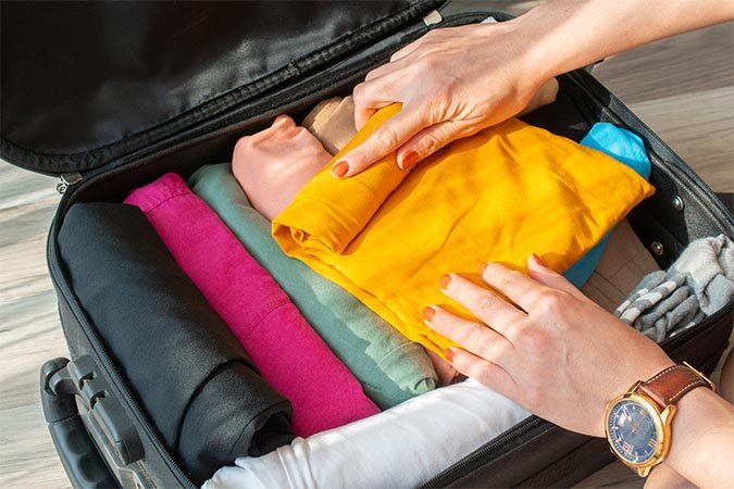 roll your clothes to pack light fountainof30 travel tip