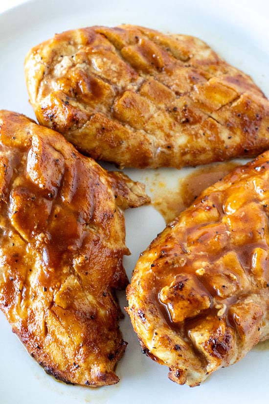 bbq chicken breasts close up on a white plate fountainof30