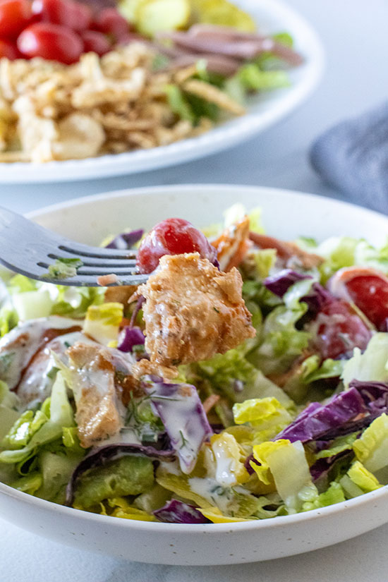 singl;e serving BBQ Crisscross Chicken Salad with fork in a bowl fountainof30