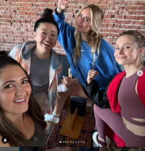 Kristen Bell in burgundy matching athletic set on Nobody Wants