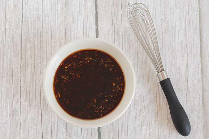 whisk together coconut aminos, sesame oil, brown sugar, garlic, ketchup, and rice vinegar.