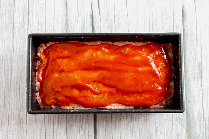 meatloaf with glaze on top before baklng