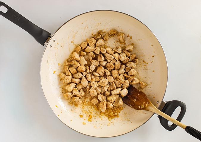 Browning chicken and spices in skillet