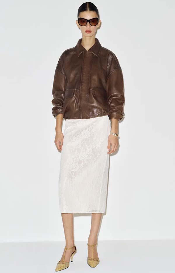 Distressed leather bomber jacket styled with a pencil midi skirt