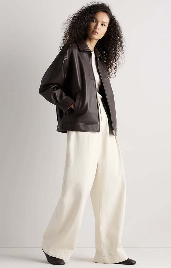 Brown oversized leather bomber jacket with wide-leg trousers
